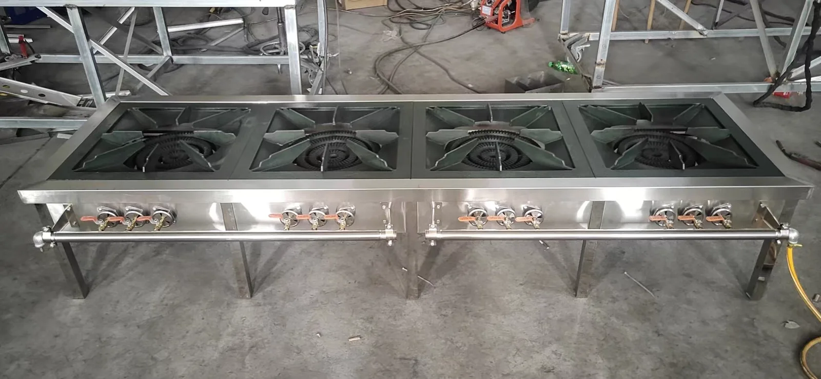 Multiple 3-ring gas stock pot stoves arranged in production line