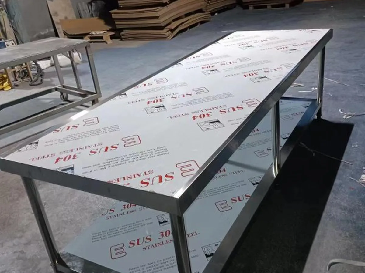 Three-tier work tables staged on the production floor for an overseas order