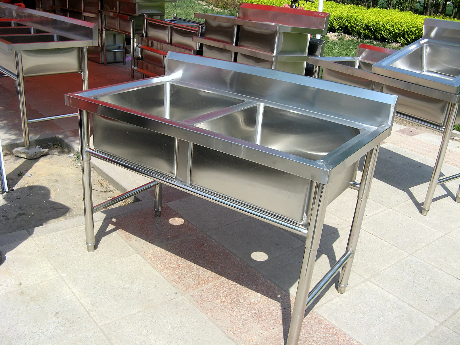 Double bowl stainless steel sink shown on site / outdoor installation