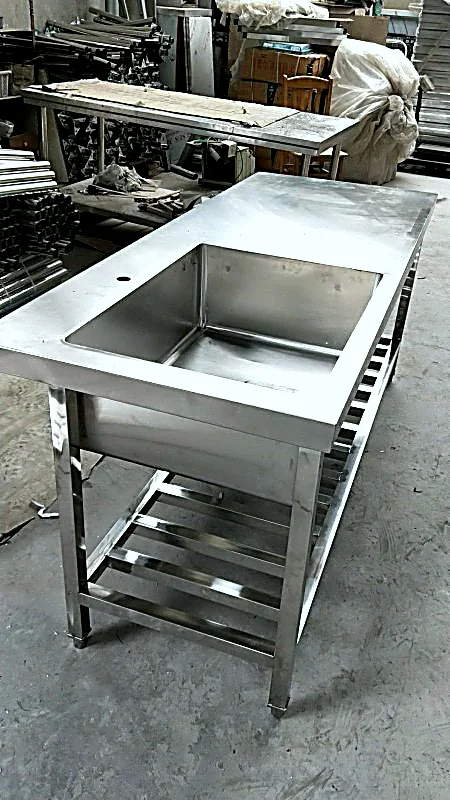 Stainless steel sink integrated with workbench counter