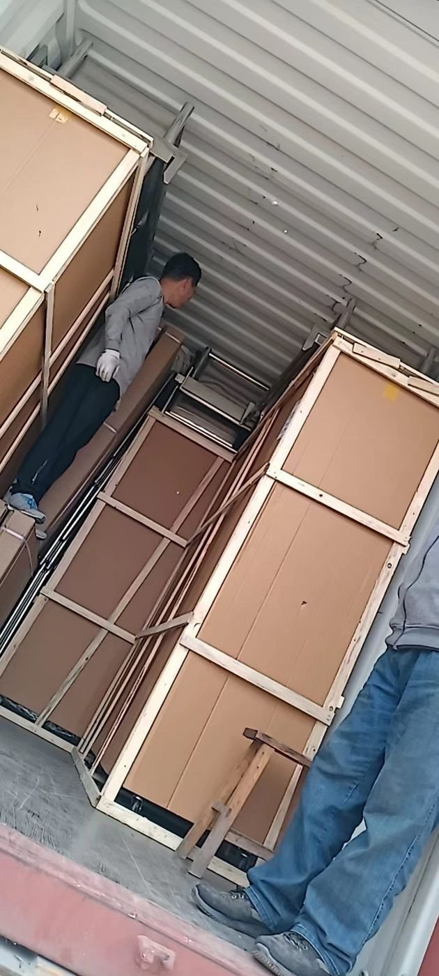 Lineup of crated rice steamer cabinets on the factory floor